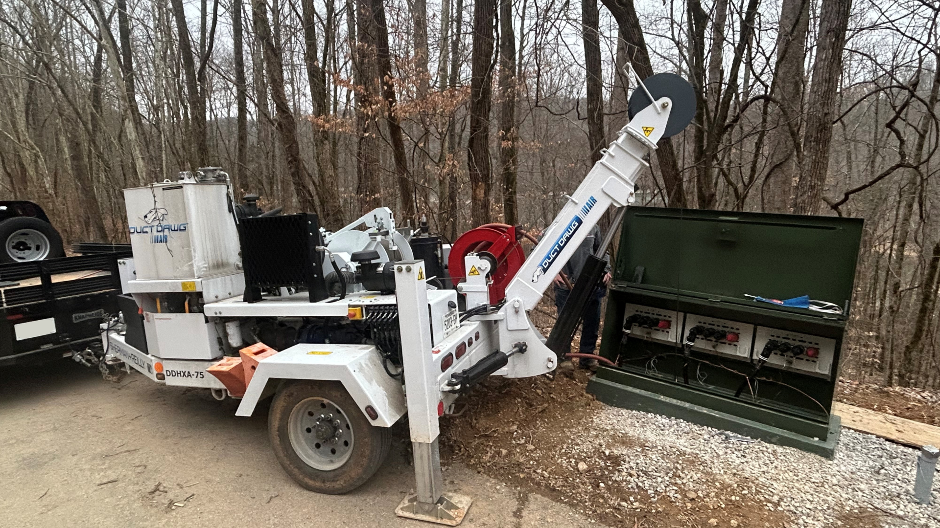 Sherman+Reilly Inc. truck with cable spools on a trailer